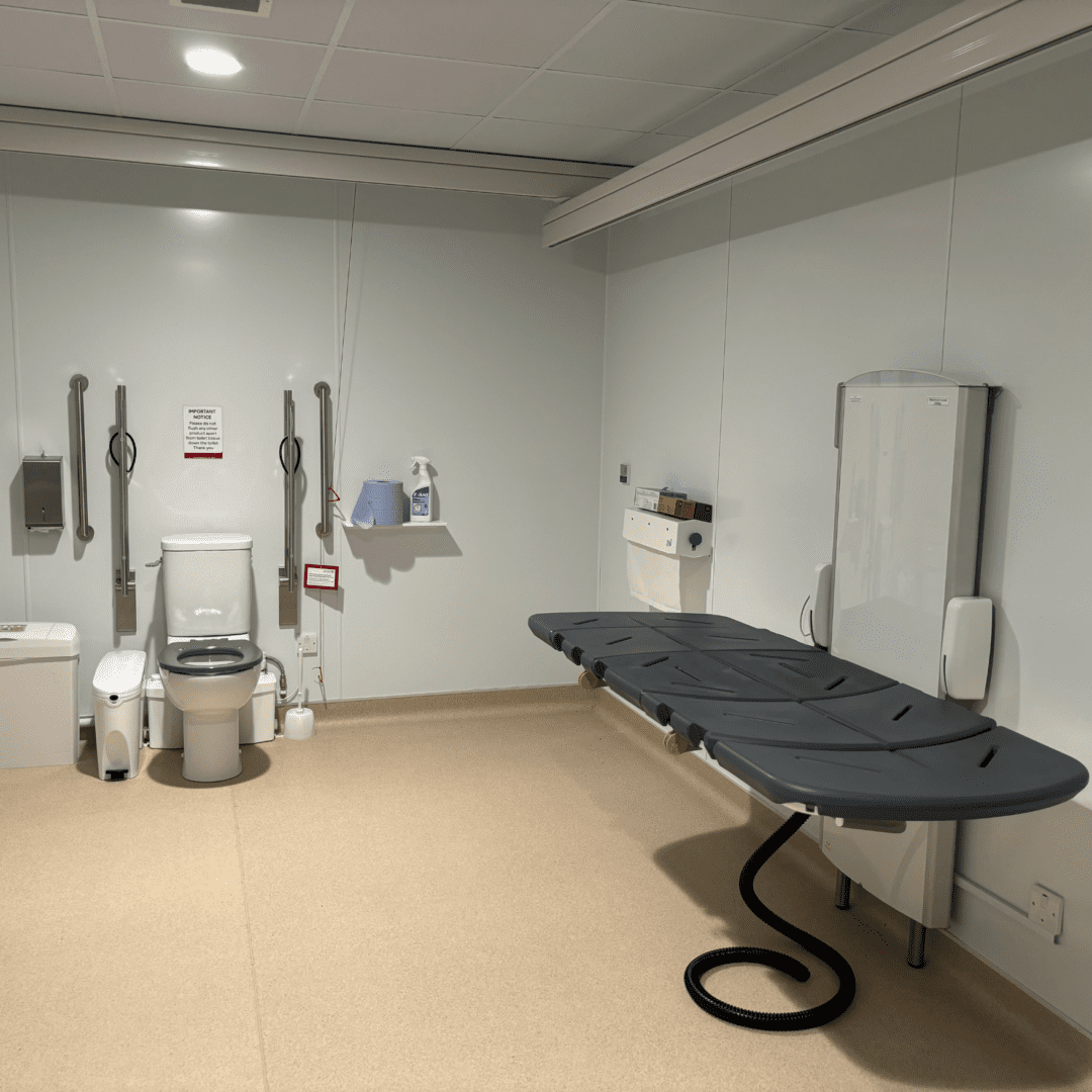 a room with a stretcher and toilet